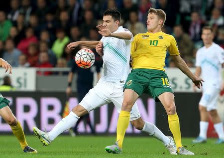 Slovenia's Branko Ilic (L) fights for the ball with Lithuania's Vykintas Slivka during their Euro 2016 qualifying soccer match in Petrol arena in Ljubljana, Slovenia, October 9, 2015. REUTERS/Srdjan Zivulovic