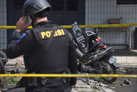 Police stand near the scene of an explosion at a church in Samarinda, East Kalimantan, Indonesia November 13, 2016 in this photo taken by Antara Foto. Antara Foto/Amirulloh/ via REUTERS