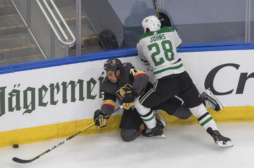 Dallas Stars' Stephen Johns (28) checks Vegas Golden Knights' Ryan Reaves (75) during the third period of an NHL hockey playoff game Monday, Aug. 3, 2020, in Edmonton, Alberta. (Jason Franson/The Canadian Press via AP)