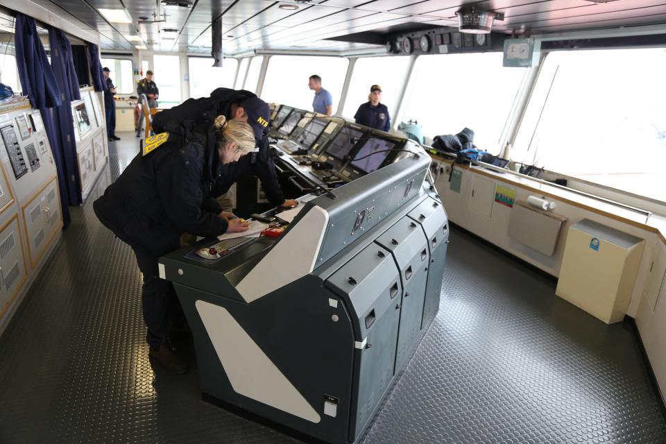 NTSB investigators are seen March 27, 2024, on the cargo vessel Dali, which struck and collapsed the Francis Scott Key Bridge on March 26, 2024.