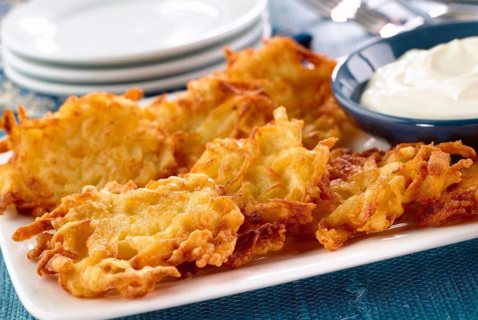 <p>Potato latkes may be the most well-known of all Hanukkah foods. This versatile dish starts with shredded potatoes, which are squeezed until dry and mixed with onions and <a href="https://www.thedailymeal.com/cook/best-egg-recipes-breakfast-dessert-dinner?referrer=yahoo&category=beauty_food&include_utm=1&utm_medium=referral&utm_source=yahoo&utm_campaign=feed" rel="nofollow noopener" target="_blank" data-ylk="slk:eggs;elm:context_link;itc:0;sec:content-canvas" class="link ">eggs</a> before being formed into a patty and fried. Foods fried or otherwise cooked with oil are symbolic call-backs to the one-day supply of oil that burned for eight in the original Hanukkah story.</p> <p><a href="https://www.thedailymeal.com/recipes/potato-latkes?referrer=yahoo&category=beauty_food&include_utm=1&utm_medium=referral&utm_source=yahoo&utm_campaign=feed" rel="nofollow noopener" target="_blank" data-ylk="slk:For the Potato Latkes recipe, click here.;elm:context_link;itc:0;sec:content-canvas" class="link ">For the Potato Latkes recipe, click here.</a></p>