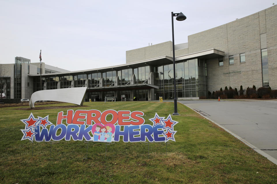 A sign in honor of hospital personnel stands outside the main entrance of the University of Vermont Medical Center, Friday, Nov. 20, 2020, in Burlington, Vt. The hospital network is still recovering from a massive digital disruption in October, signaling the dangers of cyberattacks on the nation's health care system during a surge of COVID-19. (AP Photo/Wilson Ring)