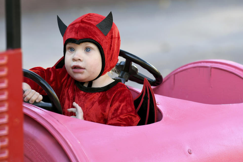 Harleigh Anderson rides a train during a Halloween celebration at Denver's Union Station on Thursday, Oct. 28, 2021. Though the pandemic remains a concern, top health officials are largely giving outside activities like trick-or-treating the thumbs up. (AP Photo/Thomas Peipert)