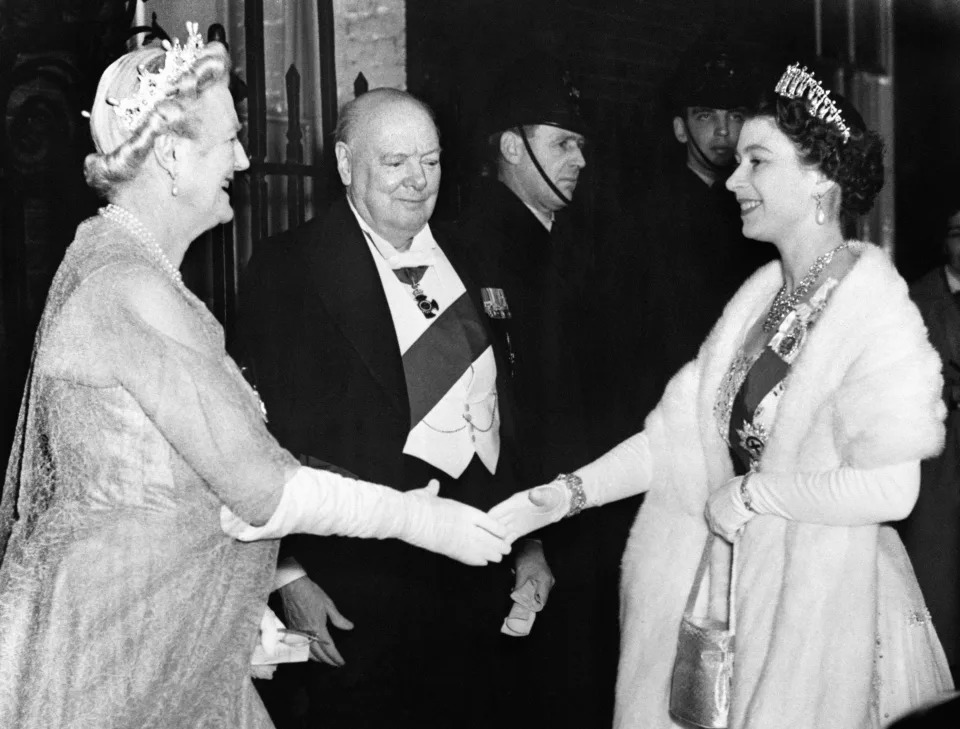 <p>The Queen is greeted by Lady Churchill and Sir Winston Churchill, as she arrives for a dinner party at No 10 Downing Street on 4 April 1955. (PA Images via Getty Images)</p> 