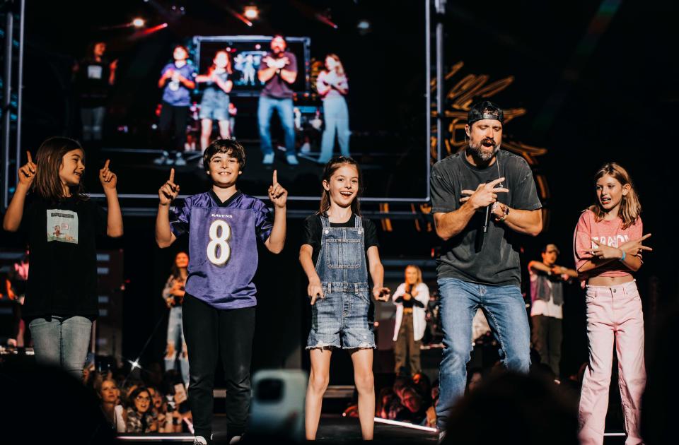 Walker Hayes and four of his kids on stage during "Fancy Like" on April 20, 2023, in Evansville, Indiana. From left, Everly, Hayes, Loxley and Walker