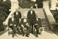 This circa 1920s photo provided by The Preservation Society of Newport County shows butler Ernest Birch, center, surrounded by footmen next to the terrace of The Elms mansion in Newport, R.I. Newly discovered photographs, documents and family histories have inspired the creation of a tour about servants at The Elms, echoing themes of the British drama program, "Downton Abbey." (AP Photo/The Preservation Society of Newport County)