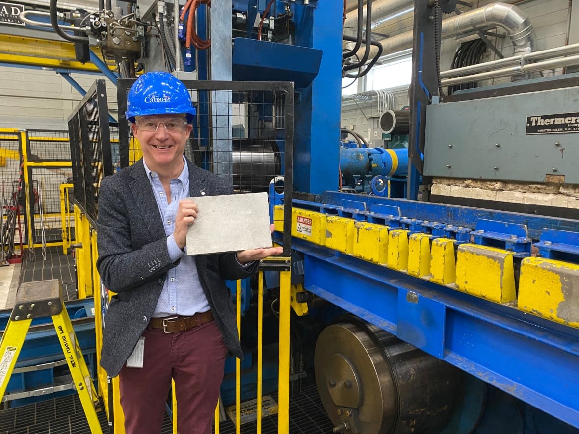 Philippe Dauphin, director general of CanmetMATERIALS, holds a piece of steel ingot from the USS Arizona. Medals of Freedom are being created from the steel to mark the 80th anniversary of the Pearl Harbor attack. (Natural Resources Canada - image credit)
