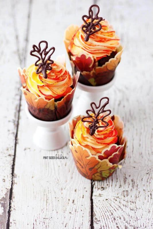 <p>Pint Sized Baker</p><p>Cupcakes are made up of red, orange and yellow swirl frosting with chocolate leaves.</p><p><strong>Get the recipe:</strong> <a href="https://pintsizedbaker.com/fall-leaves-cupcakes/" rel="nofollow noopener" target="_blank" data-ylk="slk:Fall Leaves Cupcakes;elm:context_link;itc:0;sec:content-canvas" class="link "><strong>Fall Leaves Cupcakes</strong></a></p>