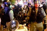 Police officers detain demonstrators during a protest in Hong Kong