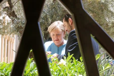 Lebanese Prime Minister-designate Saad al-Hariri stands with German Chancellor Angela Merkel at the government palace in Beirut, Lebanon June 22, 2018. REUTERS/Mohamed Azakir