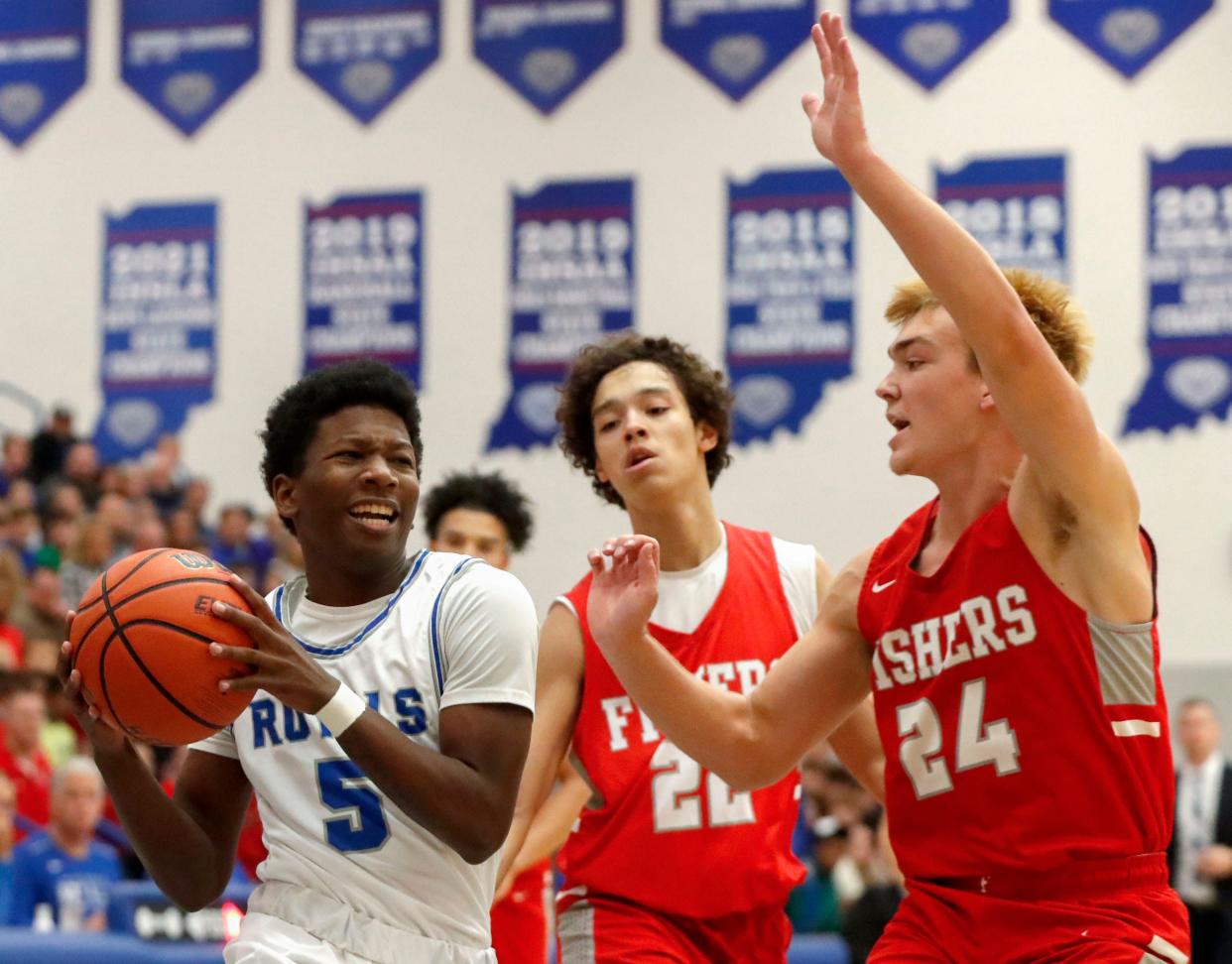 Hamilton Southeastern's Deion Miles (5) goes for a lay-up while being blocked by Fishers High School's Charlie Smith (24) during the first half of a game Friday, Dec. 17, 2021, at Hamilton Southeastern High School. The Fishers High School Tigers defeated the Hamilton Southeastern Royals 70-68.