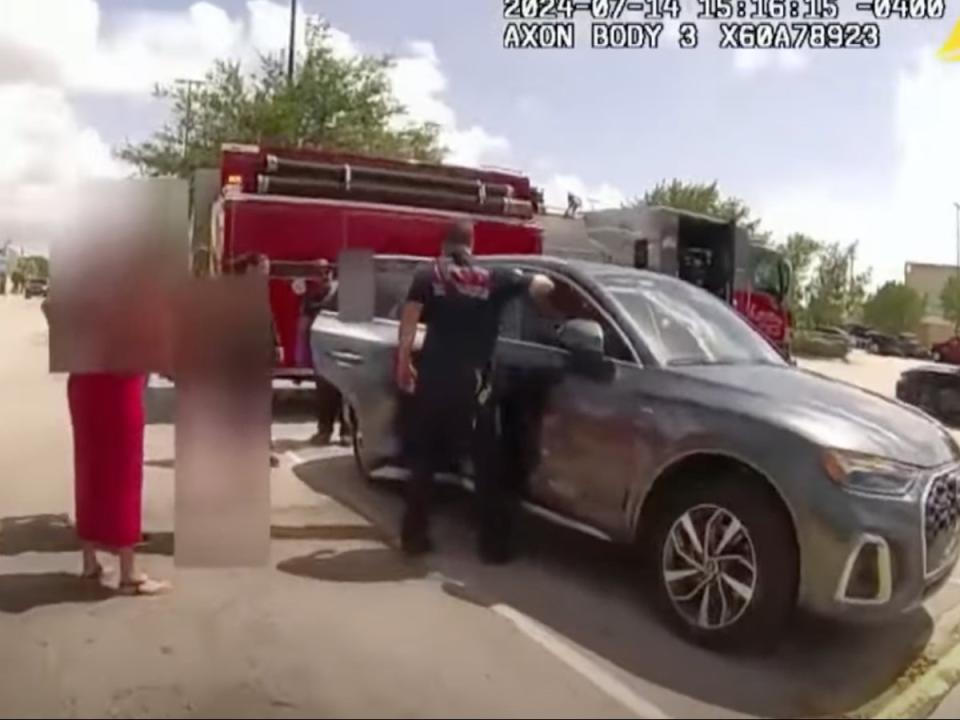 Footage from a Hollywood Police Officer bodycam in Hollywood, Florida, shows local fire crews rescuing a child that had been locked in a hot car while her mother, Anastasiya Motalava, was shopping (Hollywood Police Department/10 Tampa Bay screengrab)