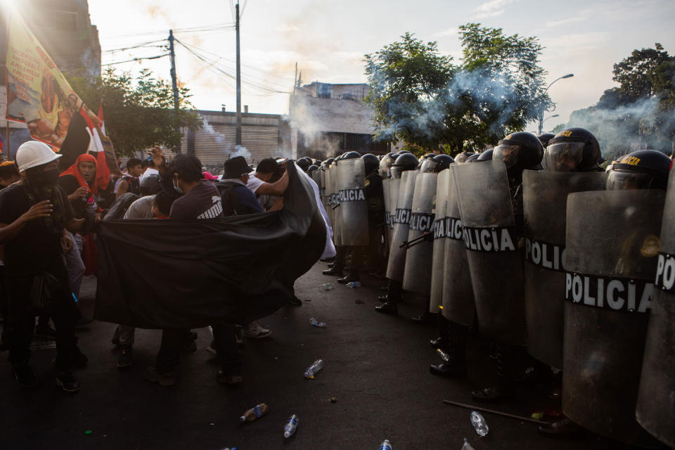 Protesters who want President Dina Boluarte to resign face off with police in Lima, Peru, on Jan. 19, 2023.<span class="copyright">Marco Garro—The New York Times/Redux</span>