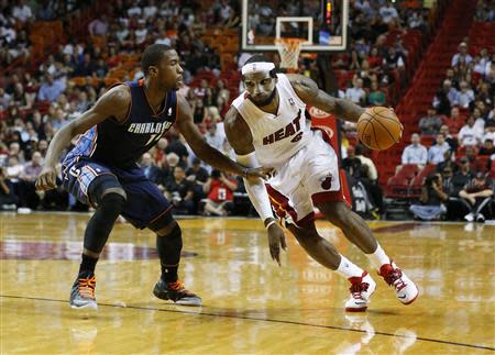 Mar 3, 2014; Miami, FL, USA; Miami Heat small forward LeBron James (6) dribbles the ball past Charlotte Bobcats small forward Michael Kidd-Gilchrist (14) in the second half at American Airlines Arena. Robert Mayer-USA TODAY Sports