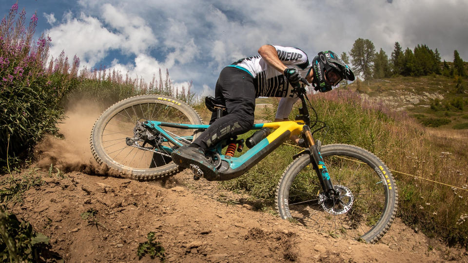 Man drifting an enduro bike through a turn