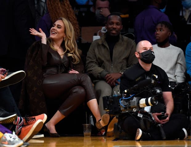 Adele wows in double denim and heels for date night at basketball game