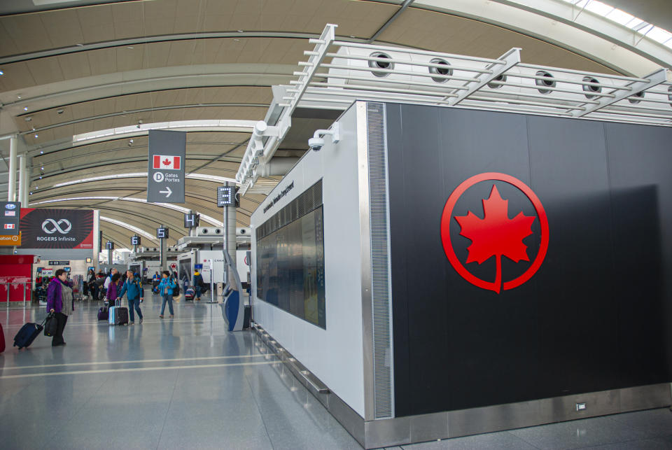 Toronto, Ontario, Canada, November 10, 2019 - People walking with luggage at the Terminal 1, Pearson International Airport, Toronto. Pearson is the biggest airport in Canada