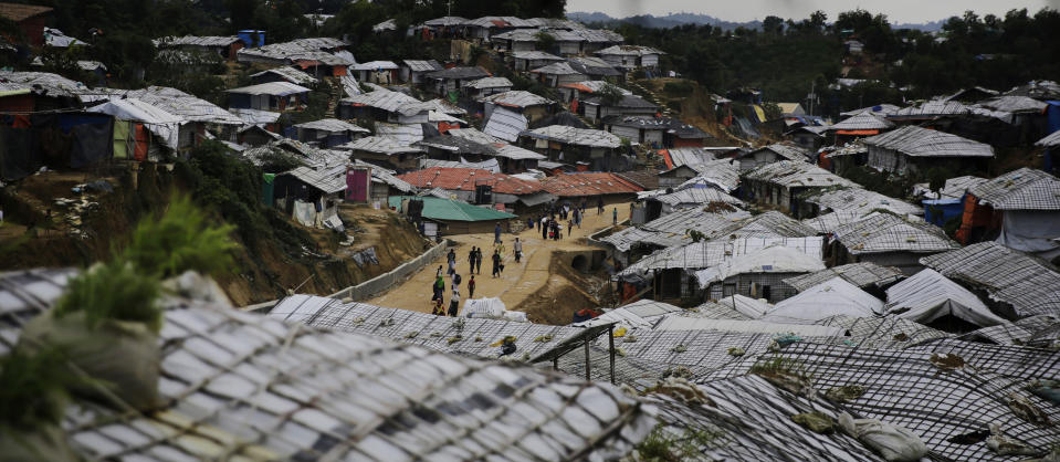 FILE - In this file photo dated Monday, Aug. 27, 2018, Rohingya refugees walk at Balukhali Refugee Camp in Bangladesh. The U.N.'s top human rights body, the Human Rights Council, agreed Thursday Sept. 27, 2018, to set up a team to collect evidence of alleged crimes committed in Myanmar against Rohingya Muslims and others since 2011, information that one day could be used to prosecute suspected perpetrators. (AP Photo/Altaf Qadri, FILE)