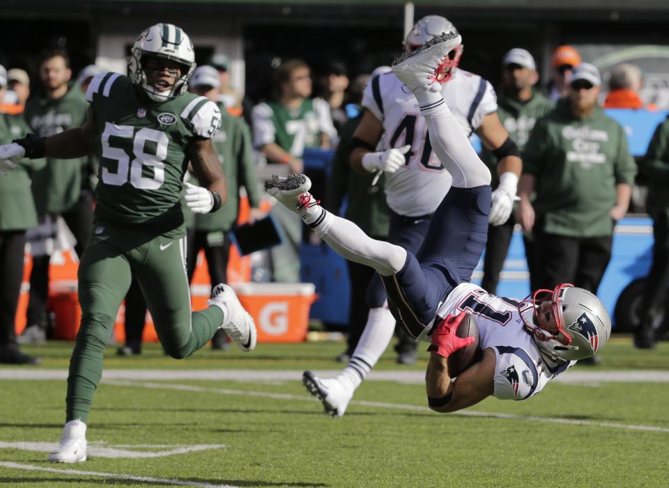 New York Jets inside linebacker Darron Lee (58) watches as New England Patriots' Julian Edelman (11) flips after being hit by teammate Darryl Roberts during the first half of an NFL football game Sunday, Nov. 25, 2018, in East Rutherford, N.J. (AP Photo/Seth Wenig)