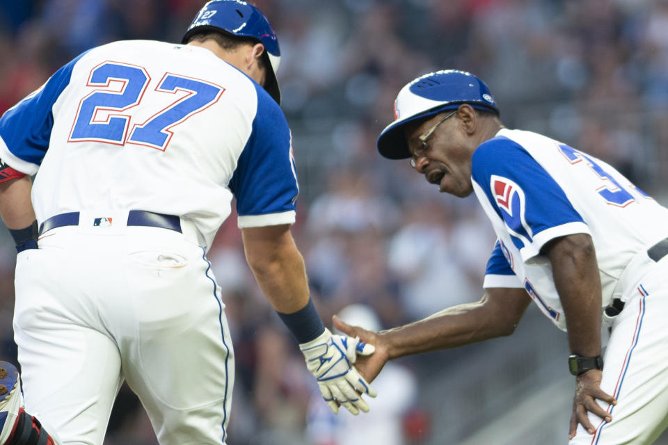 Atlanta Braves third base coach Ron Washington (37) celebrates with Austin Riley (27), who hit a home run against the Milwaukee Brewers during the first inning of a baseball game Friday, July 30, 2021, in Atlanta. (AP Photo/Hakim Wright Sr.)