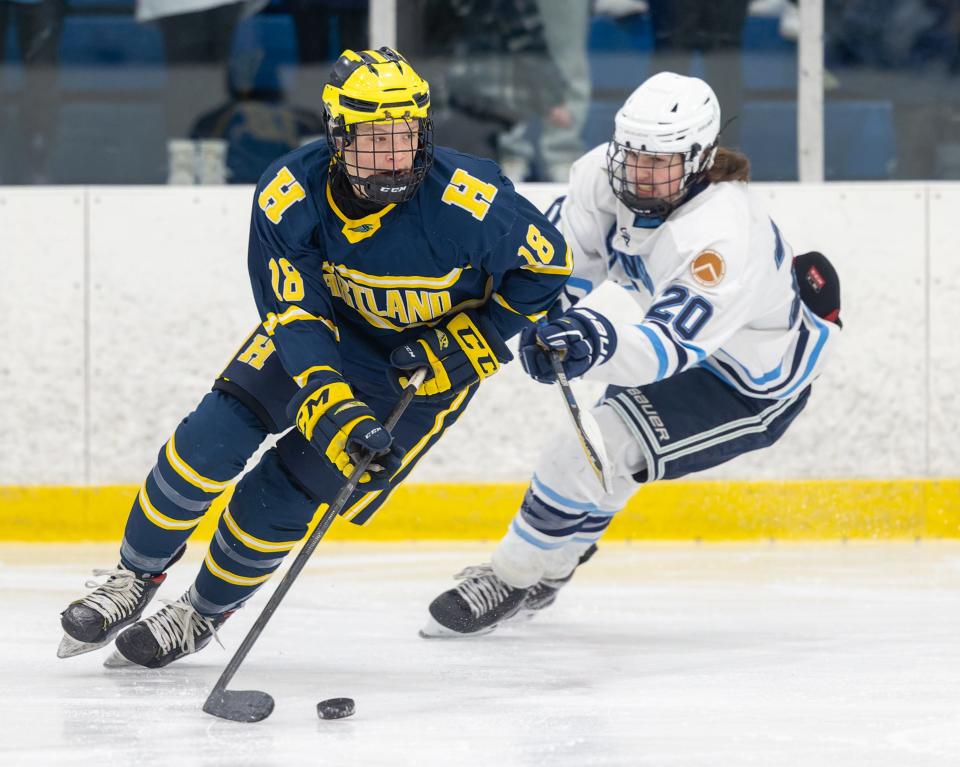 Jack L'Esperance (18), who scored Hartland's second goal, is pursued by Livonia Stevenson's Jeff Rand (20) during the Eagles' 3-1 victory on Wednesday, Jan. 26, 2022 at Eddie Edgar Ice Arena.