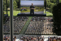 A large screen shows Apple CEO Tim Cook during an announcement of new products on the Apple campus in Cupertino, Calif., Monday, June 10, 2024. (AP Photo/Jeff Chiu)