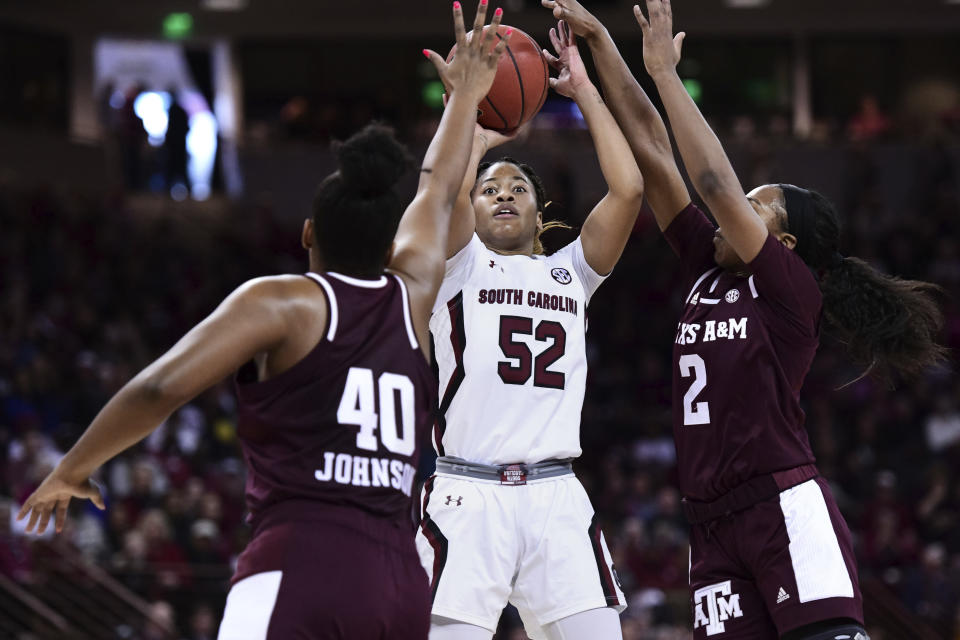 South Carolina guard Tyasha Harris (52) attempts a shot against Texas A&M guard Aaliyah Wilson (2) and Ciera Johnson (40) during the first half of an NCAA college basketball game Sunday, March 1, 2020, in Columbia, S.C. (AP Photo/Sean Rayford)