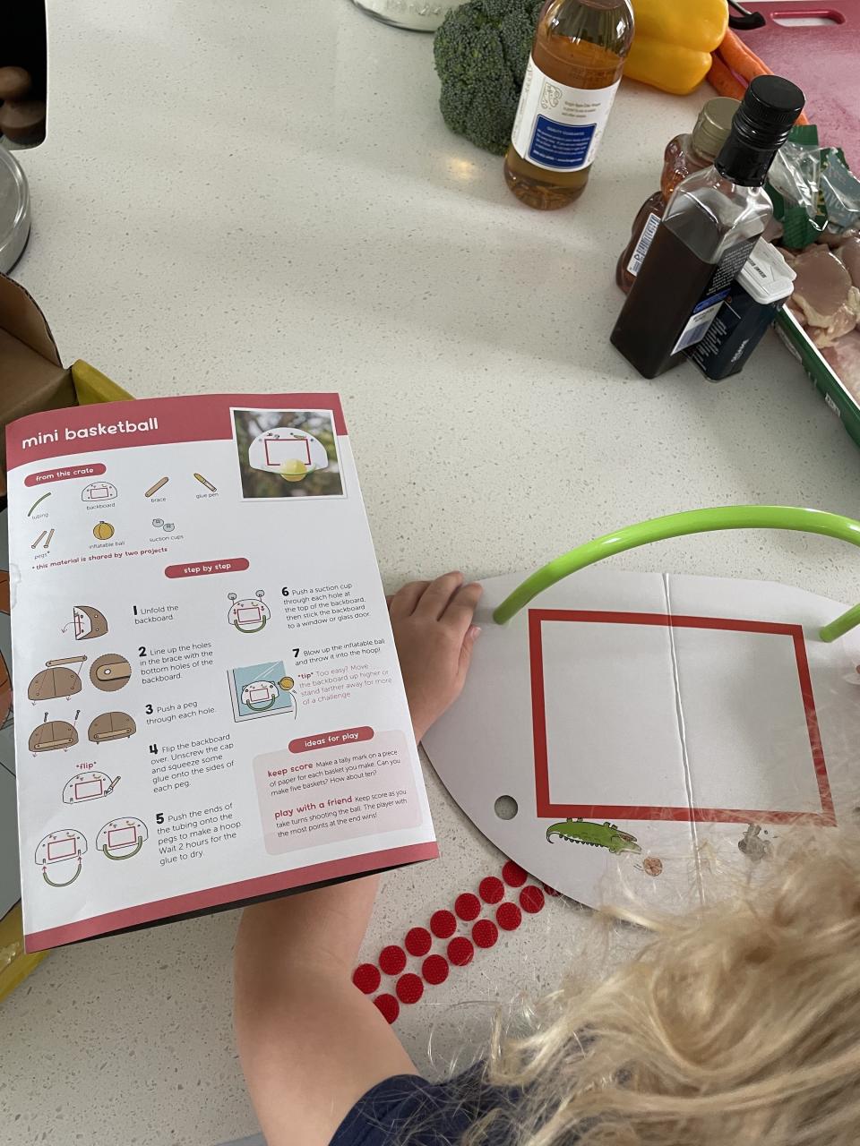 author's daughter building a basketball hoop