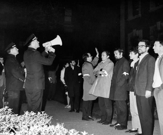 A police officer uses a bullhorn to talk to students at Columbia University.