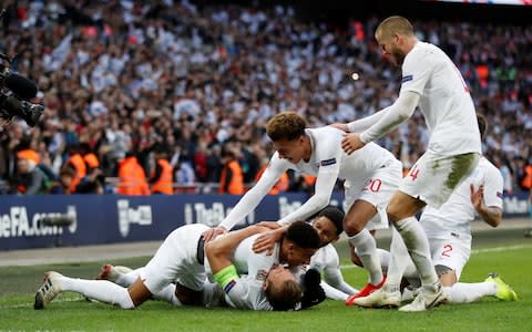 England's Harry Kane celebrates scoring their second goal with team mates - Credit: Reuters