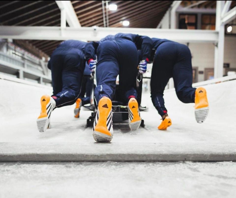 Charlie Volker (center) practices with teamates at Lake Placid, N.Y.