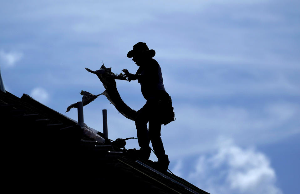A roofer works on a new home under construction Thursday, July 18, 2019, in Houston. A heat wave is expected to send temperatures soaring close to 100 degrees through the weekend across much of the country. The National Weather Service estimates that more than 100 heat records will fall on Saturday. Most will not be the scorching daily highs, but for lack of cooling at night, something called nighttime lows. Those lows will be record highs. (AP Photo/David J. Phillip)