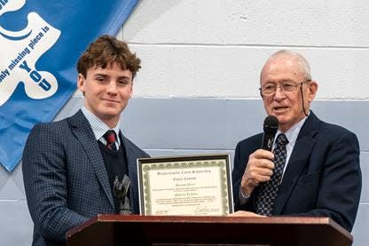 Dick Newbert, right, of theLegacyof1776.com presents Patrick Lichtner, a senior at Holy Ghost Prep, with a certificate acknowledging his second-place essay in a civics essay contest.