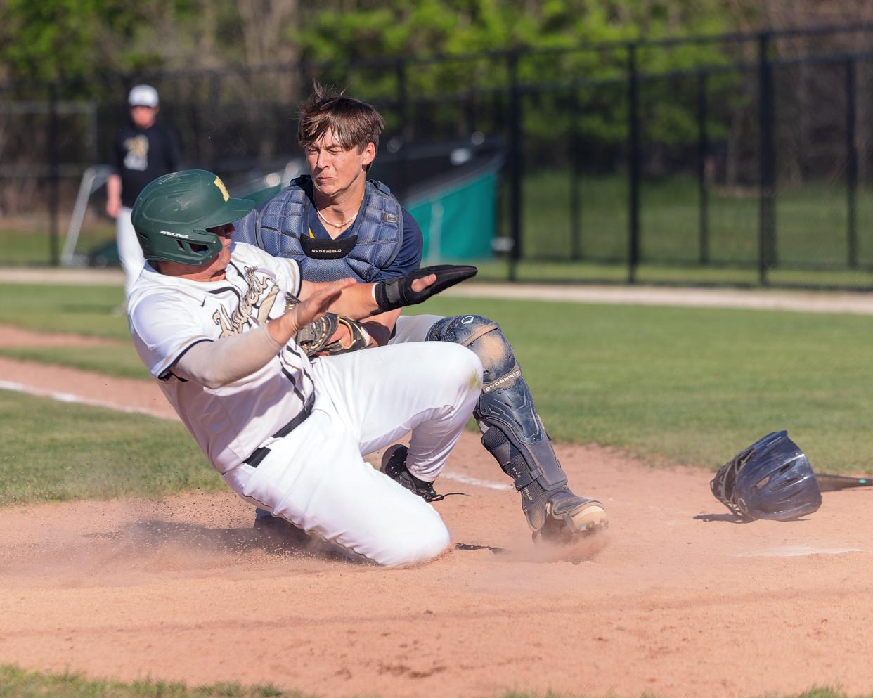 Hartland's catcher Brayden Crowe tags out Howell's Neko Hall to complete a double play off a throw from center fielder Michael Zielinski Monday, May 6, 2024.