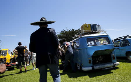 People look over entries for the "Worst of Show" award at the Concours d'Lemon, part of the Pebble Beach Concours d'Elegance in Seaside, California, August 15, 2015. REUTERS/Robert Galbraith