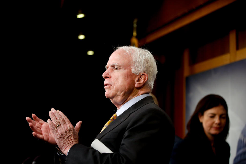 Senate Armed Services Committee Chairman Sen. John McCain (R-Ariz.) applauds the final comments from fellow committee member, Sen. Lindsey Graham (R-S.C.), as they conclude a news conference on Capitol Hill in Washington on March 26, 2015, to discuss the situation in Yemen. Sen. Kelly Ayotte (R-N.H.) is at right.