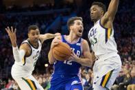 Nov 20, 2017; Philadelphia, PA, USA; Philadelphia 76ers guard T.J. McConnell (12) drives to the basket as Utah Jazz forward Thabo Sefolosha (22) and guard Donovan Mitchell (45) defend during the third quarter at Wells Fargo Center. Bill Streicher-USA TODAY Sports