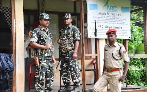 Security personnel stand guard at a National Register of Citizens office ahead of the release of the register's final draft in Guwahati - Credit: BIJU BORO/AFP/Getty Images