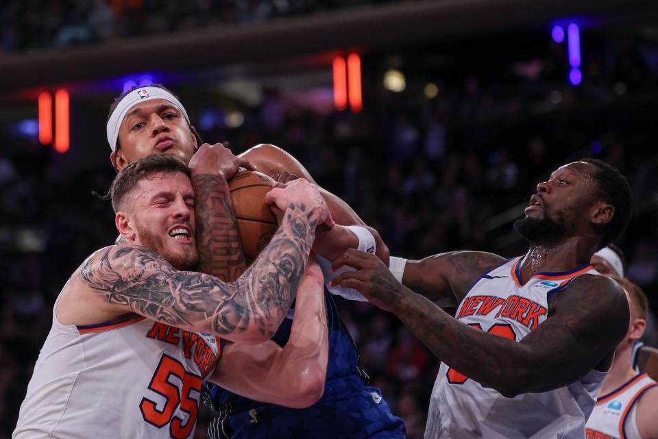 Jan 15, 2024; New York, New York, USA; Orlando Magic forward Paolo Banchero (5) rebounds against New York Knicks center Isaiah Hartenstein (55) and forward Julius Randle (30) during the second half at Madison Square Garden. Mandatory Credit: Vincent Carchietta-USA TODAY Sports