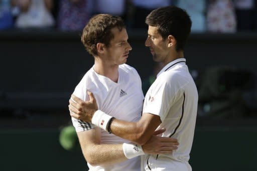 Britain's Andy Murray (L) embraces Serbia's Novak Djokovic after Murray's victory in the men's singles final on day thirteen of the 2013 Wimbledon Championships at the All England Club in Wimbledon, southwest London, on July 7, 2013. Djokovic and Murray have now contested three of the last four Grand Slam finals