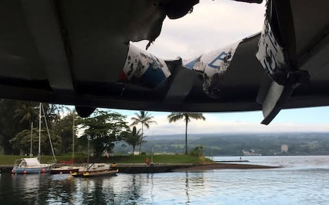 Damage to the roof of a tour boat after an explosion sent lava flying through the roof off the Big Island of Hawaii - Credit: AP