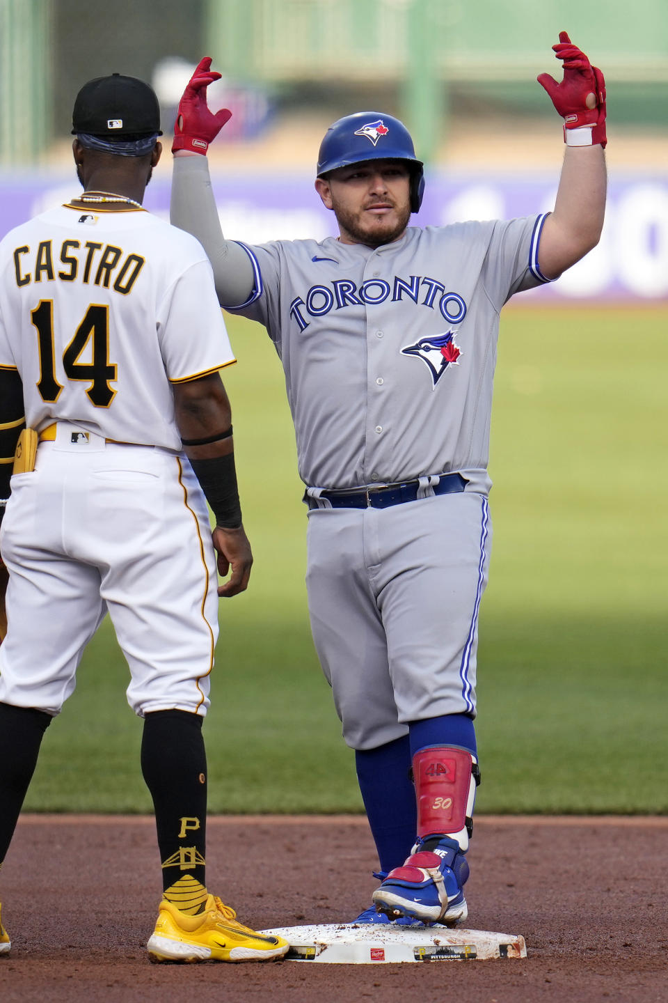 Toronto Blue Jays' Alejandro Kirk, right, celebrates as he stands on second base after driving in a run with a double off Pittsburgh Pirates starting pitcher Johan Oviedo during the first inning of a baseball game in Pittsburgh, Saturday, May 6, 2023. (AP Photo/Gene J. Puskar)