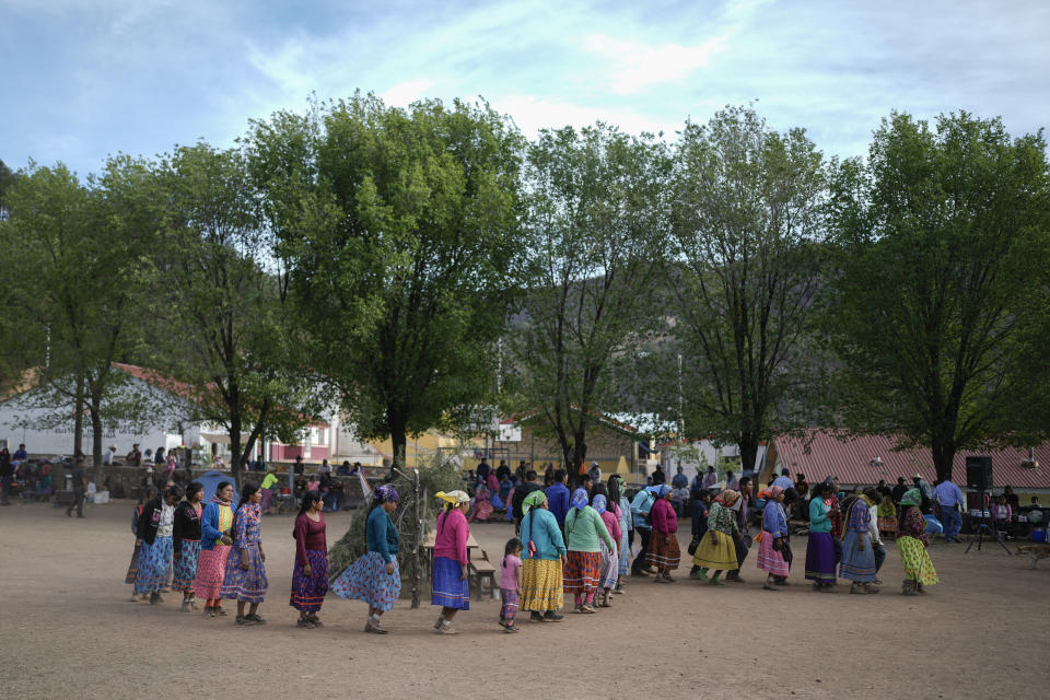 Raramuri Indigenous circle an altar during a sacred Yumari ceremony in Cuiteco, Mexico, Friday, May 10, 2024. Local communities organize competitions as part of their religious ceremonies and bet clothing, money and livestock, which inspire runners to run not for themselves, but for their people. (AP Photo/Eduardo Verdugo)