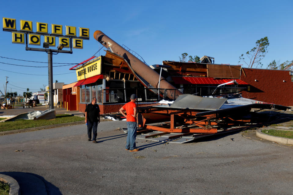 People inspect a Waffle House damaged by Hurricane Michael in Callaway, Florida, U.S. October 11, 2018. REUTERS/Jonathan Bachman