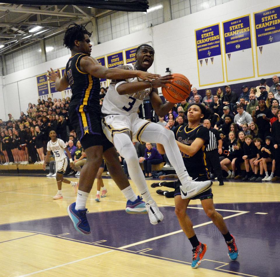Smithsburg's Ja'Von Tyler drives to the basket and is fouled by Loch Raven's Brandon Tyler during the first half of the Leopards 96-82 victory in the Maryland Class 1A state quarterfinals at Smithsburg. Tyler scored 17 of his game-high 24 points in the fourth quarter.