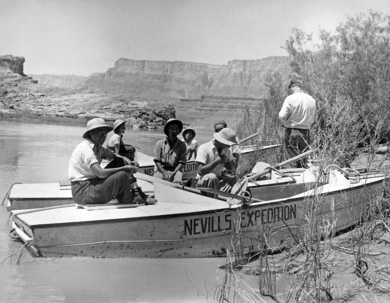 Victors over 300 miles of the turbulent Colorado River, the six members of the Nevills expedition as they arrived safely at Leeís Ferry, Arizona, July 8, 1938. Left to right: Dr. Elzada Clover, Lois Jotter, Eugene Atkinson, Don Harris, Norman D. Nevills, W.C. Gibson (behind Nevills, wearing bandanna) and an unidentified man, not a member of the expedition.