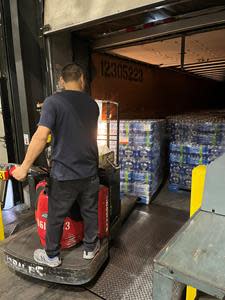 An ADUSA Distribution Associate loads the water onto the truck for delivery to God’s Pantry Food Bank in Lexington, KY.