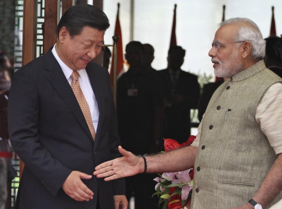 FILE - In this Sept. 17, 2014, file photo, Indian Prime Minister Narendra Modi, right, welcomes Chinese President Xi Jinping, upon his arrival at a hotel in Ahmadabad, India. India’s Ministry of External Affairs said Wednesday, Oct. 9, 2019, that Xi and Modi would meet for a second informal summit in the southern coast city of Chennai on Oct. 11 and 12 to “exchange views on deepening” the two countries’ development. (AP Photo/Ajit Solanki, File)