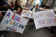 Young girls hold signs as they join several thousand other protestors to demonstrate during a rally apposing the nuclear deal with Iran in Times Square in the Manhattan borough of New York City, July 22, 2015. REUTERS/Mike Segar