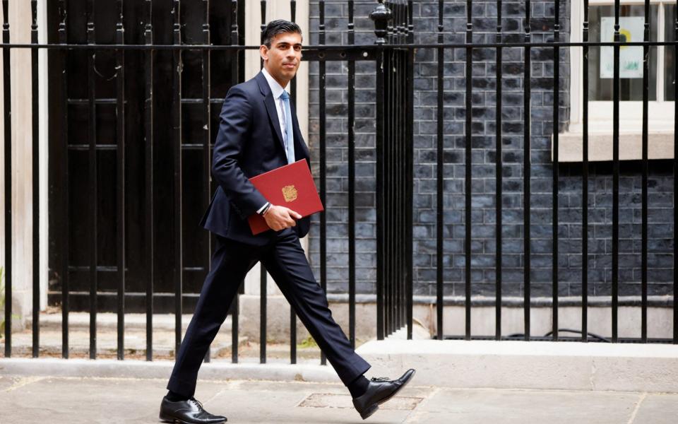 Rishi Sunak is pictured leaving Downing Street this morning ahead of delivering a statement in the House of Commons - John Sibley/Reuters